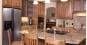 Kitchen island with wooden chairs around it